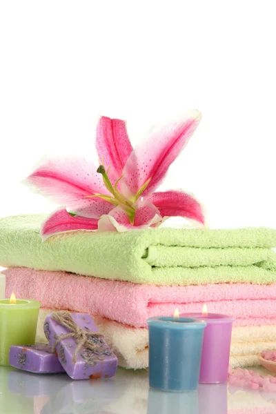 Towels with lily, aroma oil, candles, soap and sea salt isolated on white — Stock Photo, Image