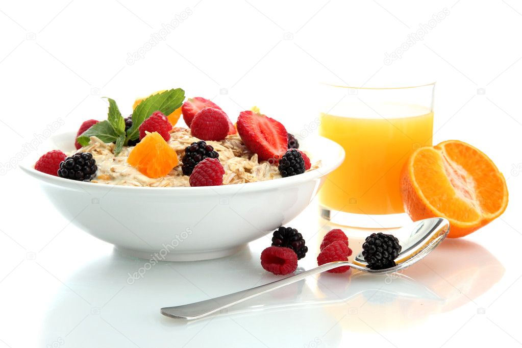 tasty oatmeal with berries and glass of juice, isolated on white