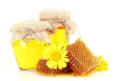 sweet honeycombs, jars with honey and flowers, isolated on white