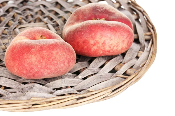 Ripe fig peaches on wicker mat isolated on white — Stock Photo, Image