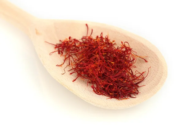 Stigmas of saffron in wooden spoon on white background close-up — Stock Photo, Image