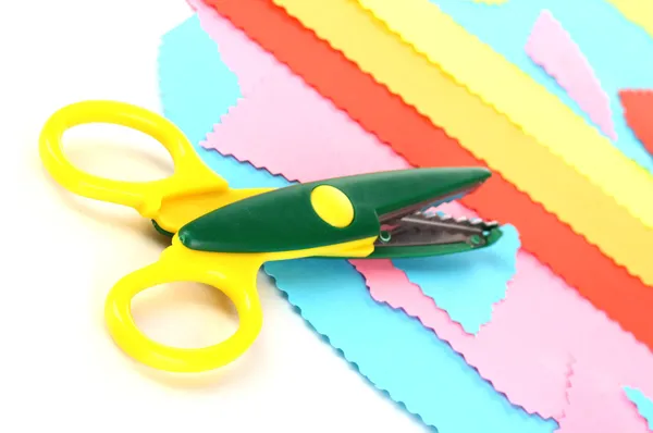 Colorful zigzag scissors with color paper isolated on white — Stock Photo, Image