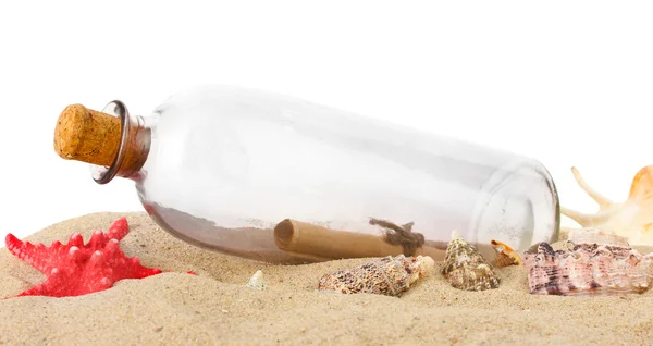 Glass bottle with note inside on sand isolated on white — Stock Photo, Image