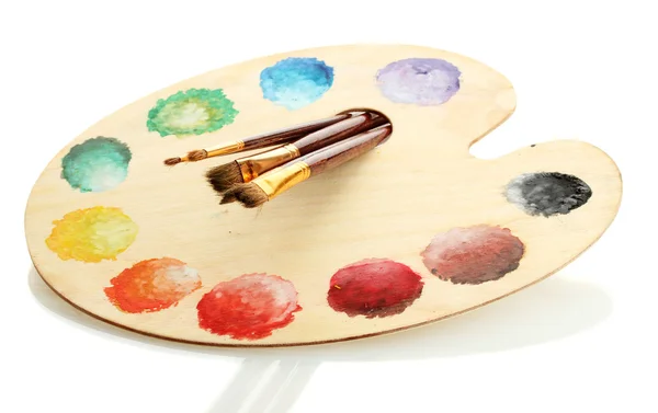 Wooden art palette with paint and brushes isolated on white — Stock Photo, Image