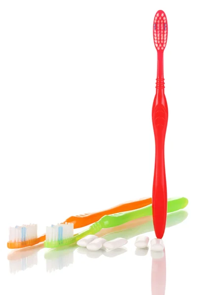 Toothbrushes and chewing gum isolated on white — Stock Photo, Image