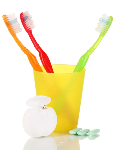 Toothbrushes, chewing gum and dental floss isolated on white — Stock Photo, Image