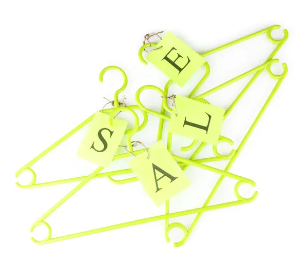 Coat hangers with sale tag isolated on white background — Stock Photo, Image