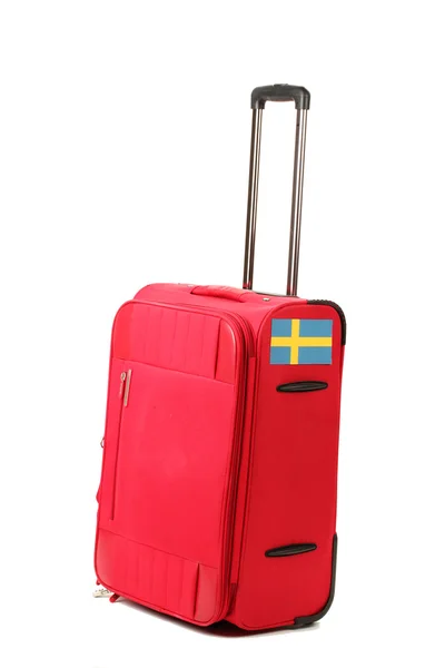 Red suitcase with sticker with flag of Sweden isolated on white — Stock Photo, Image