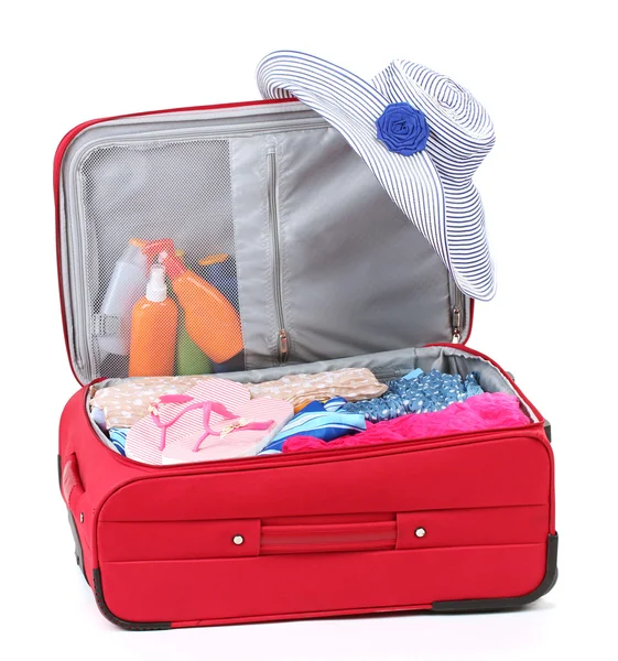 Suitcase with summer clothes, a hat and suntan isolated on white — Stockfoto