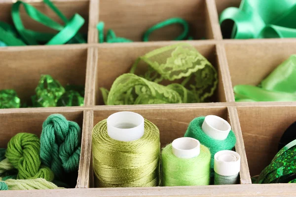 Green thread and material for handicrafts in box close-up — Stock Photo, Image