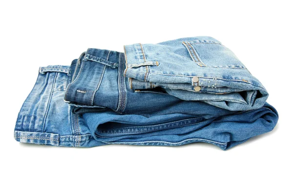 Several fashion blue jeans isolated on white — Stock Photo, Image