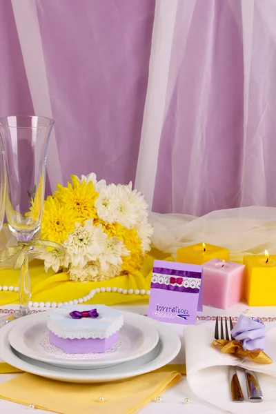 Serving fabulous wedding table in purple and blue color of the restaurant background