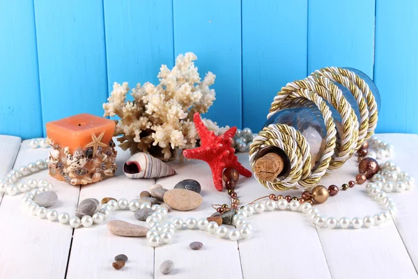 Decor of seashells on wooden table on blue wooden background — Stock Photo, Image