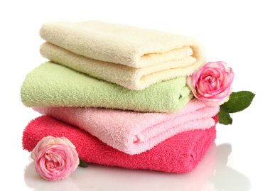 bright towels and roses isolated on white
