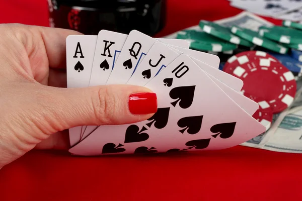 Woman's hand holding playing cards royal flush — Stock Photo, Image