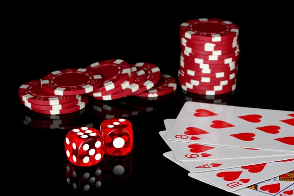 Flush with poker chips and dice on black background — Stock Photo, Image