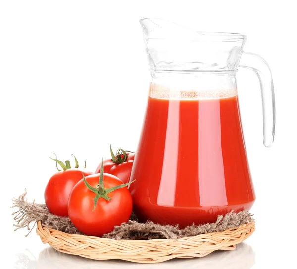 Tomato juice in pitcher on wicker mat isolated on white — Stock Photo, Image