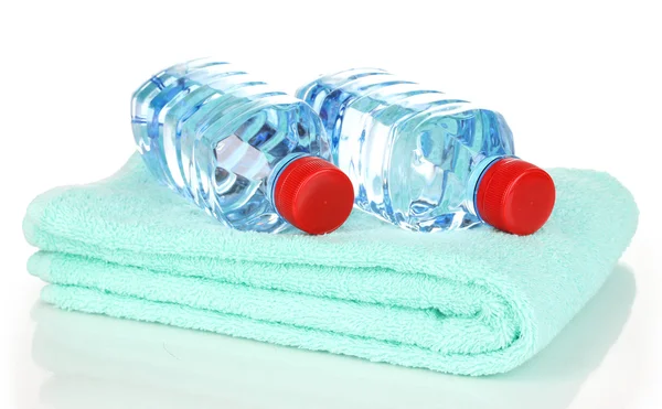 Plastic bottles of water on towel isolated on white — Stock Photo, Image