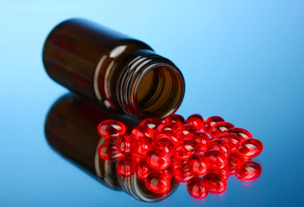 Jar of pills on blue background close-up — Stock Photo, Image