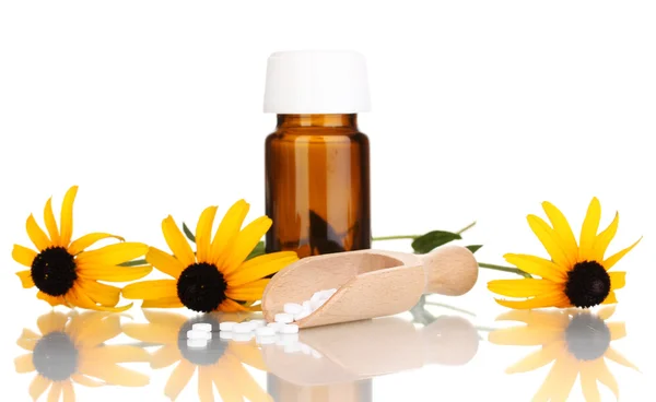 Medicine bottle with tablets and flowers isolated on white — Stock Photo, Image