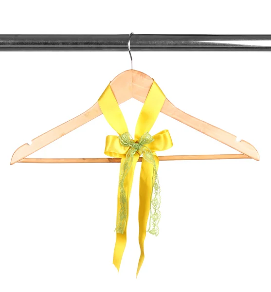 Beautiful yellow bow hanging on wooden hanger isolated on white — Stock Photo, Image