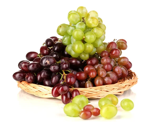 Delicious ripe pink and green grapes on wicker cradle isolated on white — Stock Photo, Image