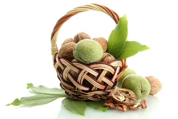 Walnuts with green leaves in basket, isolated on white — Stock Photo, Image