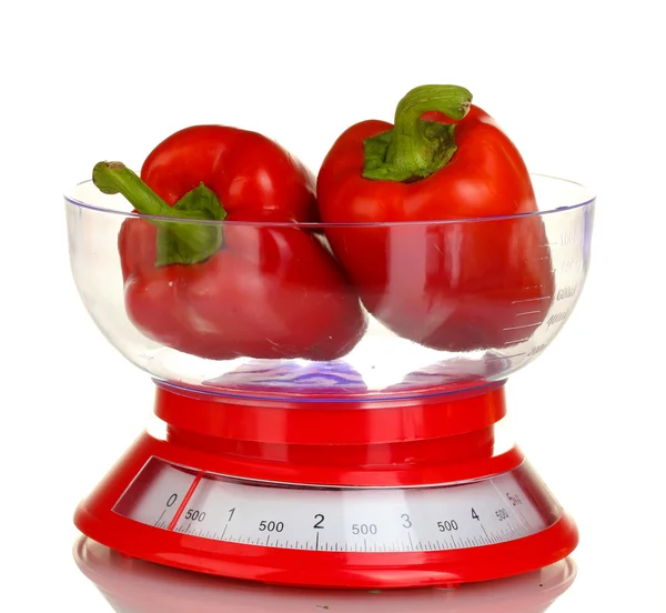 Fresh red peppers in a kitchen scales isolated on white — Stock Photo, Image