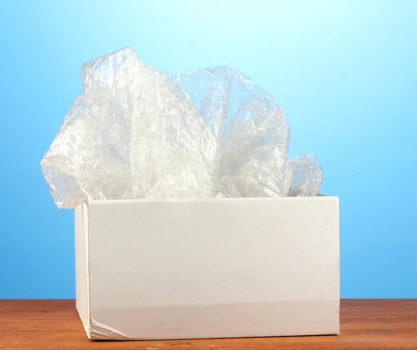 Opened parcel on blue background close-up — Stock Photo, Image