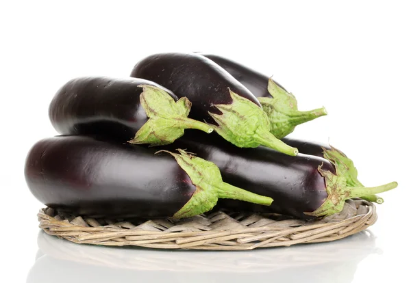 Fresh eggplants on wicker mat isolated on white — Stock Photo, Image