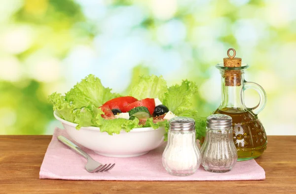 Tasty greek salad on bright green background — Stock Photo, Image