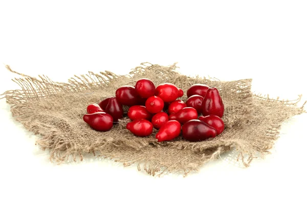 Fresh cornel berries on sackcloth isolated on white — Stock Photo, Image