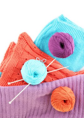 colorful wool sweaters and balls of wool close-up clipart