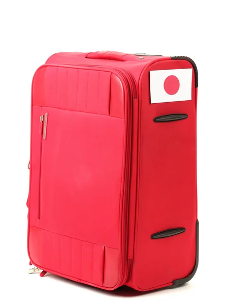 Red suitcase with sticker with flag of Japan isolated on white — Stock Photo, Image