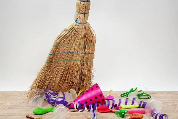 Broom sweep the trash after a party on white background close-up — Stock Photo, Image