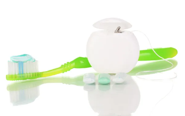 Toothbrush, chewing gum and dental floss isolated on white — Stock Photo, Image