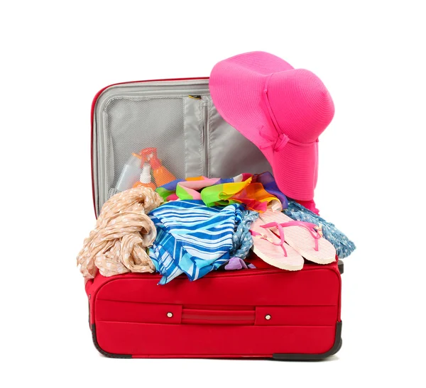 Suitcase with summer clothes, a hat and suntan isolated on white — Stock Photo, Image