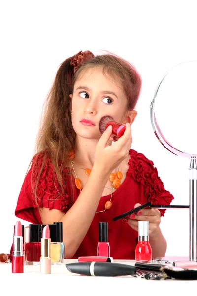 Little girl in her mother's dress, is trying painting her face — Stock Photo, Image