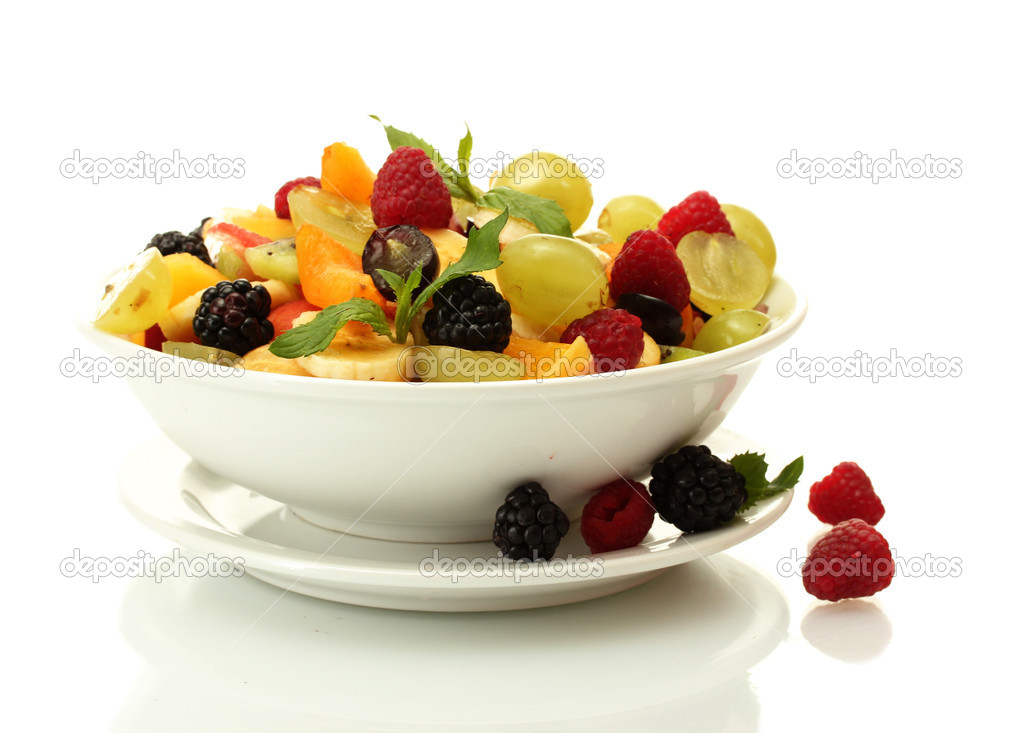 fresh fruits salad in bowl and berries, isolated on white