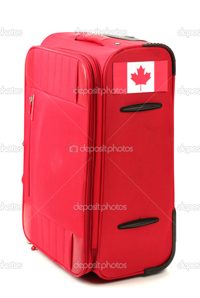red suitcase with sticker with flag of Canada isolated on white