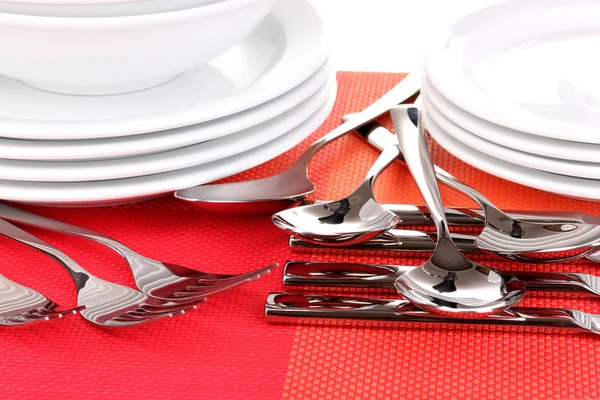 Forks, knifes and spoons on red mat close-up — Stock Photo, Image