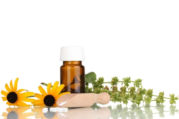 Medicine bottle with tablets and flowers isolated on white — Stock Photo, Image