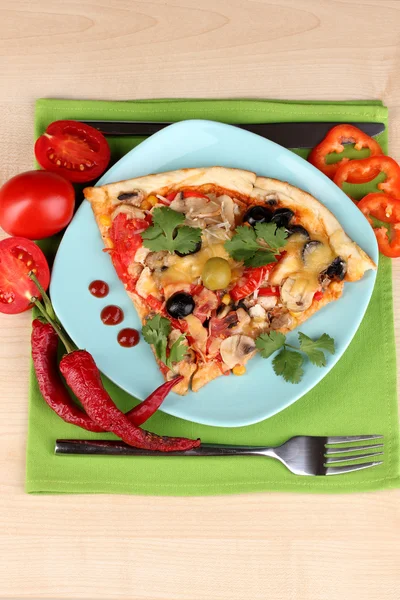 Delicious slice of pizza on color plate with ingredients around close-up on — Stock Photo, Image