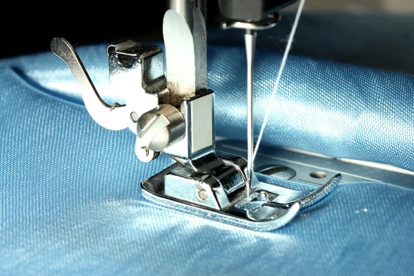 Sewing machine with blue cloth closeup — Stock Photo, Image