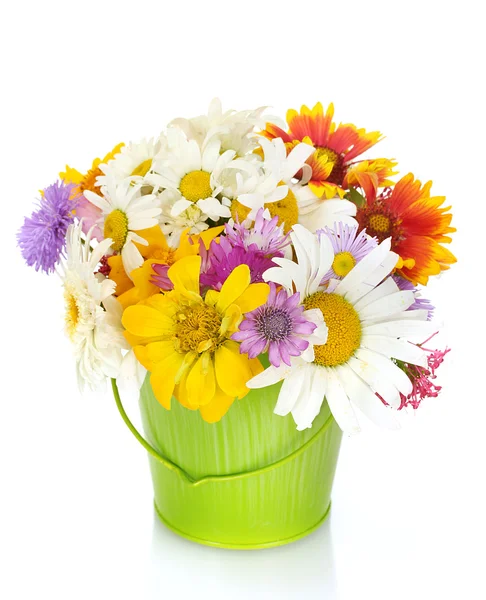 Beautiful bouquet of bright wildflowers in green metal bucket, on wooden t — Stock Photo, Image