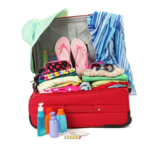 Valigia da viaggio rossa con oggetti personali isolati su bianco — Foto Stock