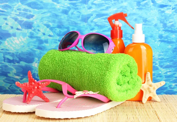 Bright beach accessories, on blue sea background — Stock Photo, Image