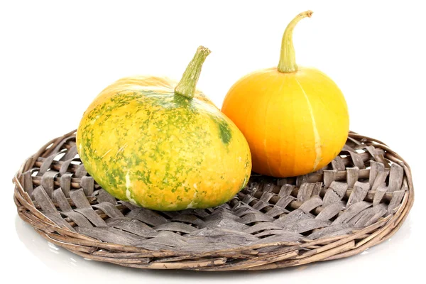 Two pumpkins on wicker mat isolated on white — Stock Photo, Image