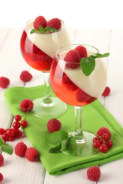 Fruit jelly with berries in glasses on wooden table — Stock Photo, Image