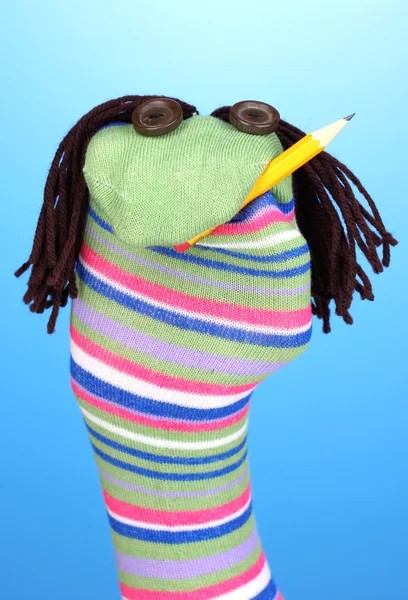 Cute sock puppet on blue background — Stock Photo, Image